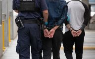 CBP officers at the San Ysidro Land Port of Entry in San Diego, California detain two male subjects for further inspection, October 25, 2023. CBP photo by Jerry Glaser.