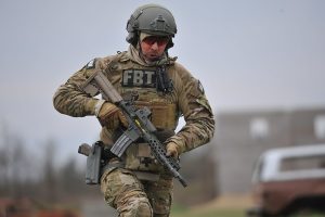 A member of the US Federal Bureau of Investigation's Milwaukee Special Weapons and Tactics team participtes in urban assault course training at range 41 at Fort McCoy Wis. on 27 April 2016.  Fort McCoy is one of three Total Force Training centers in the United states and trains more than 100,000 US military personel each year.  Many of the training facilities are also available to federal, state and local law enforcement.  Photo by Jamal Wilson