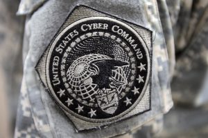 U.S. Army soldier proudly wears the United States Cyber Command patch during exercise “Cyber Guard 2015”.  The two-week “Cyber Guard 2015” exercise was held at Suffolk, Virginia and was attended by partners from across government, academia, international coalition, and industry. The purpose of the exercise was to perform operational and interagency coordination as well as tactical level operations to protect, prevent, mitigate, and recover from a cyberspace incident during “Cyber Guard 2015”.  (Department of Defense Photo by Marvin Lynchard)
