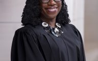 official portrait photograph of Justice Ketanji Brown Jackson taken September 20, 2024, the justice is pictured in her Judicial robe and a Visible collar made of Metal, and decorative stones / gems. This version is a 1/2 lenghth portrait. a headshot crop is also available.