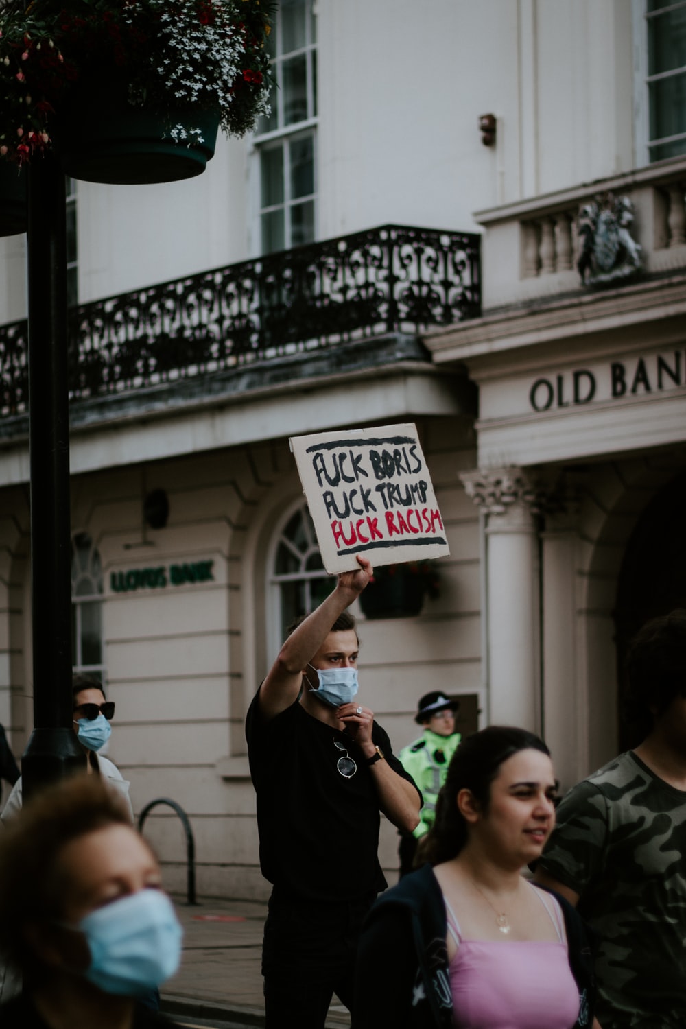 people holding white and black signage during daytime